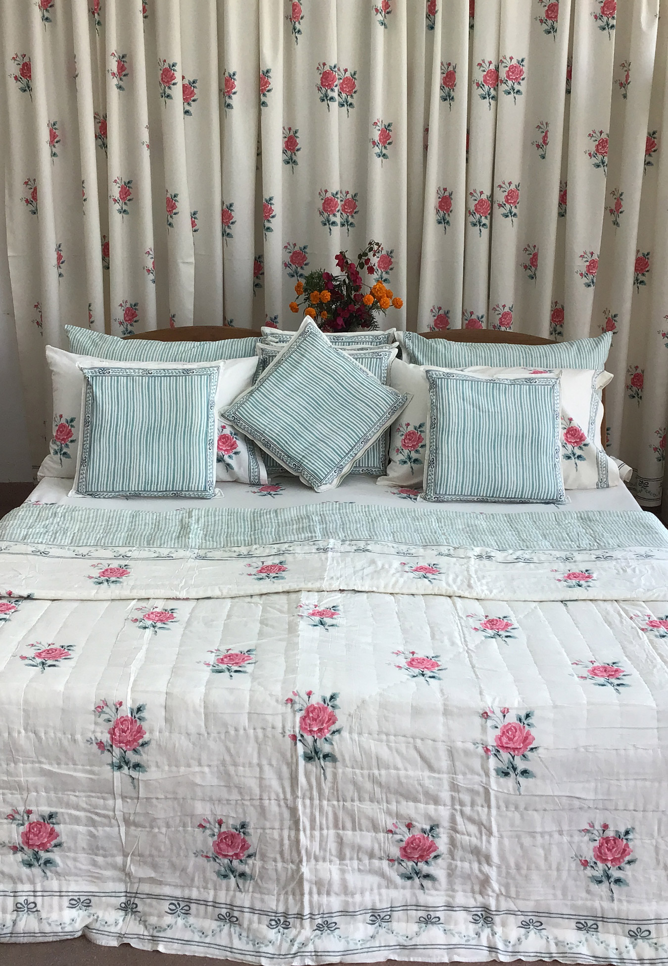 white quilt with pink flower